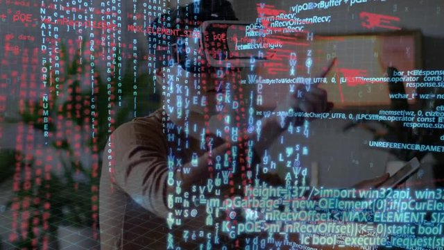 Man wearing virtual goggles and holding a tablet