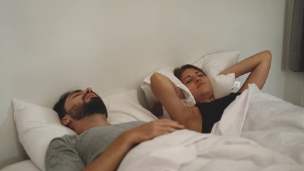 Couple with snoring problem concept, Woman has problem form her husband snoring while sleeping on bed