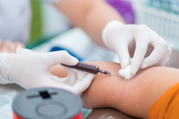 Nurse collecting a blood from patient in hospital