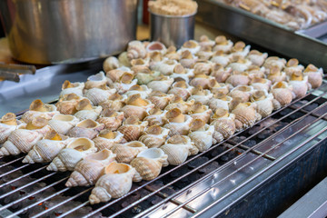 Grilled sea snails or fresh shells on the grill at Taipei street food