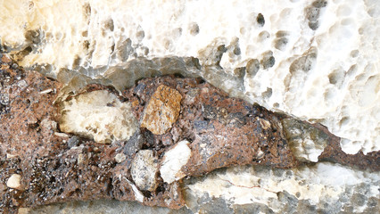 Texture of natural stone. Modern background. Image. Design for poster. Abstract backdrop. Black, grey, biege, sepia. Hole on the surface. Patterns and textures of rocks in nature. Closeup detail stone