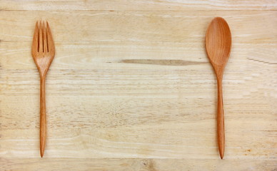 top view spoon and fork on wooden background with copy space