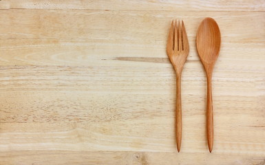 top view spoon and fork on wooden background with copy space