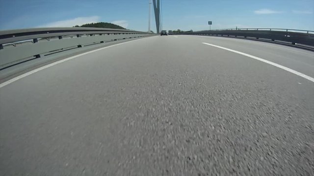 A highly stylized clip of a car speeding down the highway on the German autobahn. Highway low angle ungrade.d