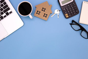flat lay Office desk table of modern workplace with laptop on blue table, top view laptop background and home wooden, blue desk office with laptop, home sale office desk concept,