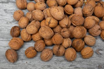 a scattering of walnuts on a wooden background close-up