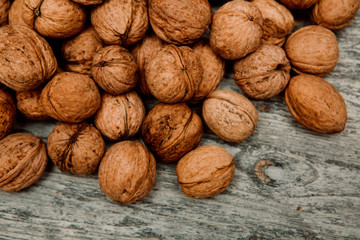 a scattering of walnuts on a wooden background close-up