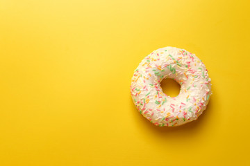 Fototapeta na wymiar white donut on yellow background top view copy space
