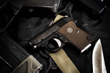 Small hidden pistol, Mini compact handgun for woman on black background, Close-up of a weapons and military equipment for army.