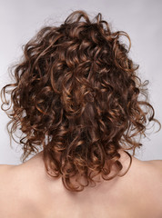 Woman from backside with curly hair