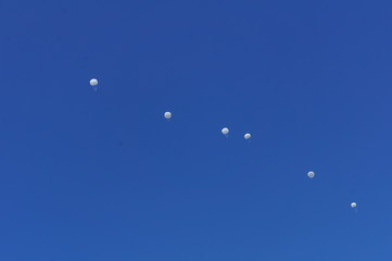 flying parachutes in the sky