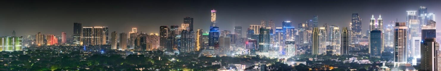Panoramic Jakarta skyline with urban skyscrapers at night