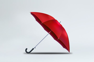 Red umbrella isolated on soft gray background. 3D rendering.