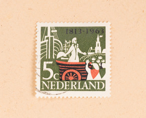 THE NETHERLANDS 1960: A stamp printed in the Netherlands shows a man in a boat, circa 1960