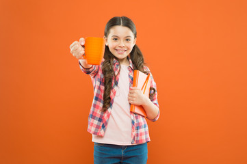 Literature for kids. Enjoy spending time at home. Hot cocoa and good book perfect combination for cozy evening. Reading bucket list. Spend nice time with favorite book. Girl hold cup of tea and book