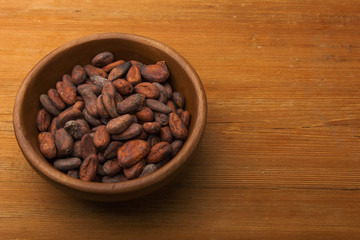 Cocoa beans on old wooden table