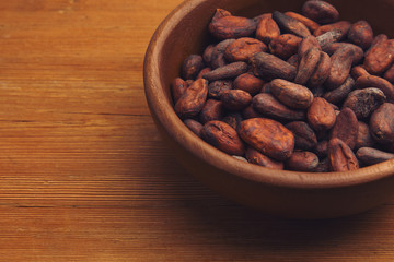 Cocoa beans on old wooden table