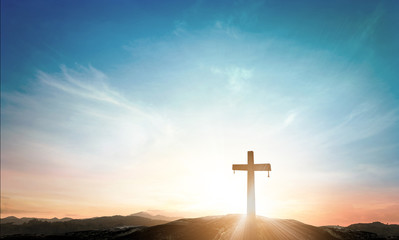 The cross on meadow autumn sunrise background