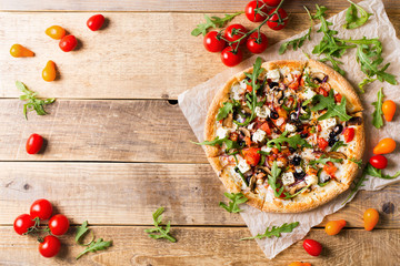 Vegetable italian pizza with tomatos on wodeen background
