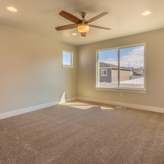 Square frame Empty room of a new house with beige wall paint and carpeted floor