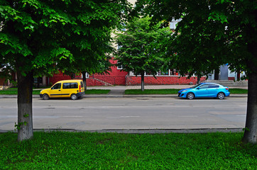 Yellow and blue cars are parked