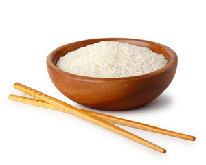 A wooden bowl with white rice and food chopsticks. Natural products, healthy food.