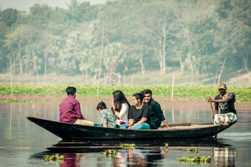 Purbasthali, OXBow Lake, Chupi, Bardhaman, West Bengal, India 1 December 2019 - Holiday people watching and photographing migratory birds in a fishing boat called Nouka during winter months.