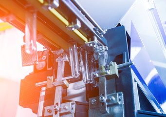 The plastic bottle blowing machine. PET preforms for blowing of plastic bottles. Heating process.