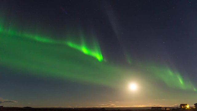 Timelapse of amazing Northern Lights at Lake Myvatn at night with full moon in view