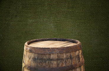 Wooden barrel on a table and textured background