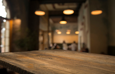 image of wooden table in front of abstract blurred background of resturant lights - 271196403