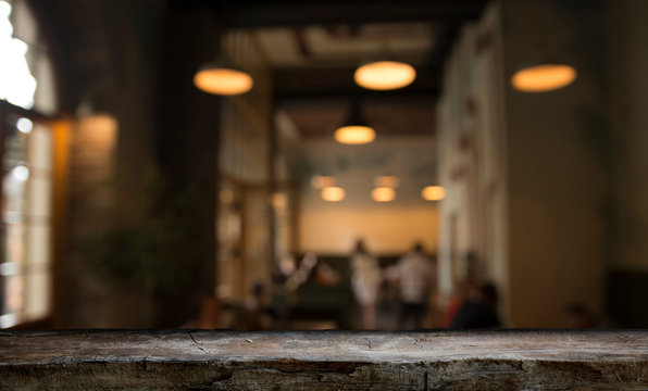 blurred background of bar and dark brown desk space of retro wood