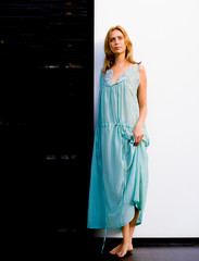 Young attractive and beautiful professional model woman with blond hair wearing high end exclusive design dress posing stylish in fashion and beauty concept