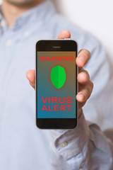 Hands holding smart phone with virus alert on screen. White background.