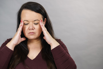 Worried woman having painfull headache