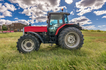 Tractor on a green meadow in spring