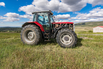 Tractor on a green meadow in spring