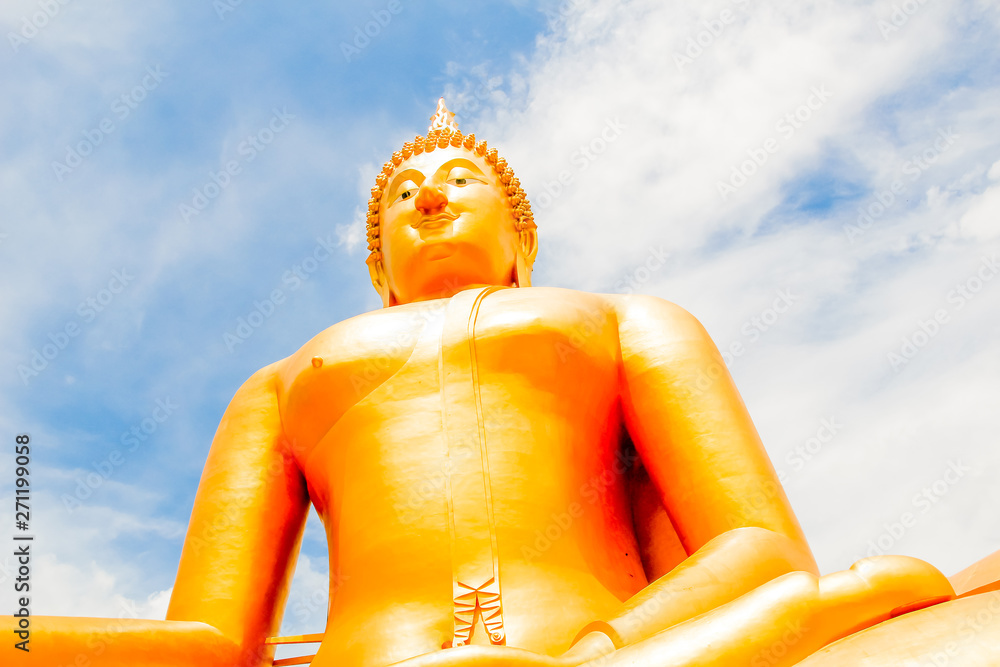 Wall mural big golden buddha with blue sky blue at wat muang, ang thong province, thailand