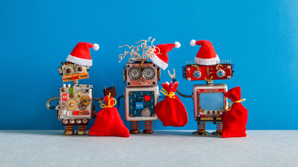 Three Christmas Santa Claus robotic toys dressed in red holiday hat. Funny smiley robots with a...