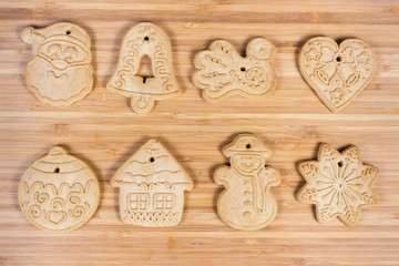 Cookies of various form laid in rows on wooden surface
