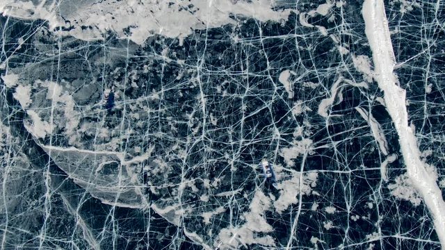 From bird view: scientists in a hovercraft explore the scenery of the north and permafrost in polar waters. Top view of the trip travelers on a great iced of the reservoir. Day in a savage place