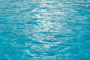Beautiful sunny blue pool water background. Horizontal color photography.