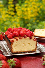 Cupcake with strawberries located on a table in the fresh air, on a metal tray