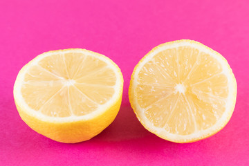Lemon on a bright pink and background. Summer ripe fruit. The concept of growing fruits, natural food rich in vitamins. Minimalism, flat lay, top view, design.