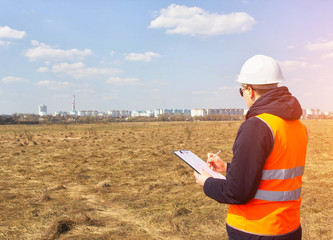 Surveyor worker measures the distance and length using measuring equipment for the construction of a new micro district, copy space, Angle measurement