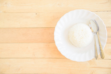 Top view of rice cooked in a dish on wood plate