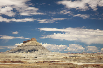 Fototapeta na wymiar Factory Butte mountain and desert landscape with big sky and clouds, Caineville Badlands, Utah.