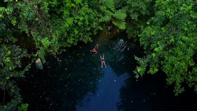 Aerial: People Swimming in a Lake in the Jungle in Espiritu Santo, Vanuatu
