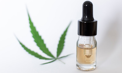 Medicinal cannabis with oil in a bottle on white background. 