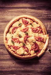 italian pizza at wooden table